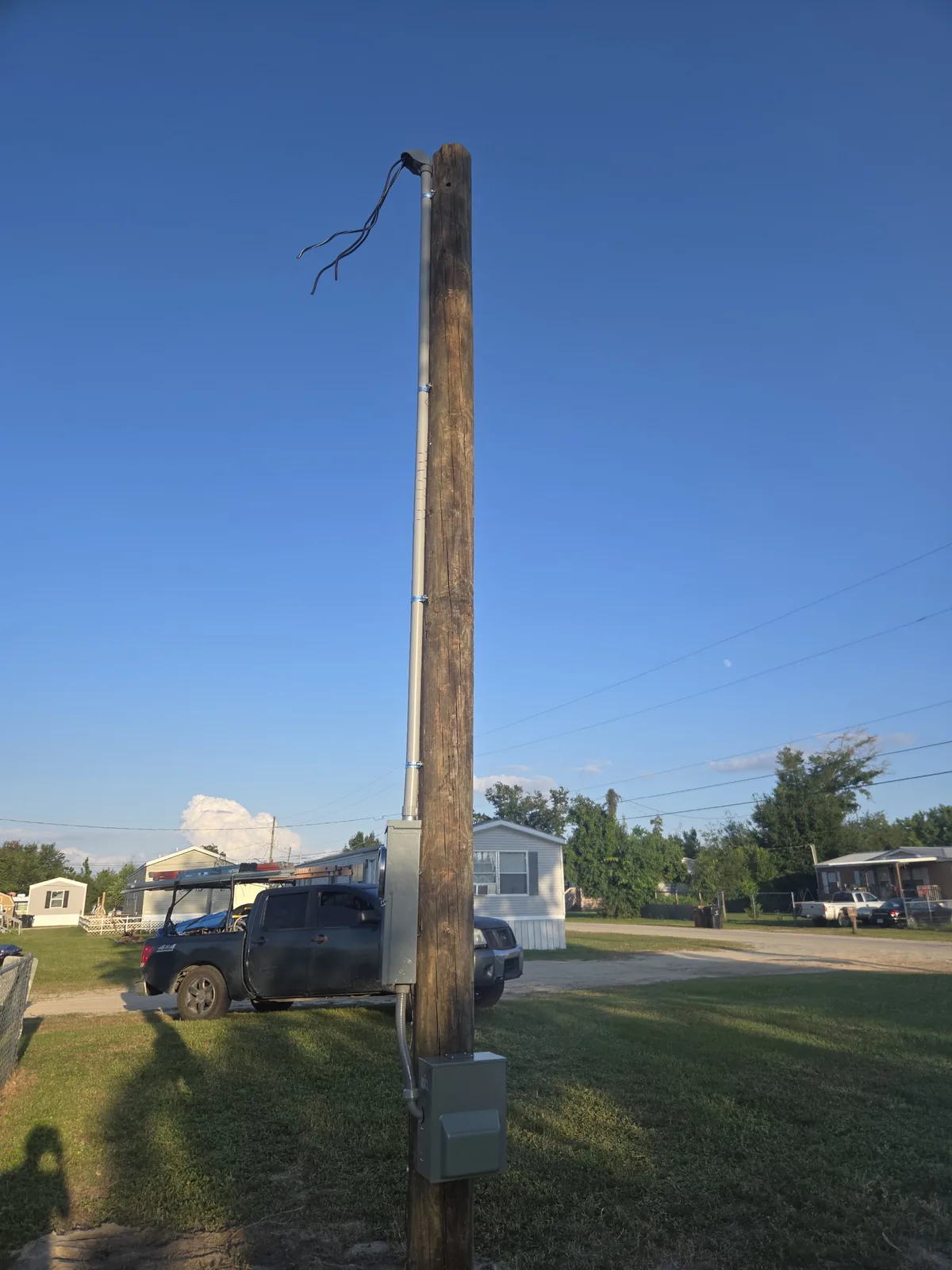 Tall parking-area light pole during installation