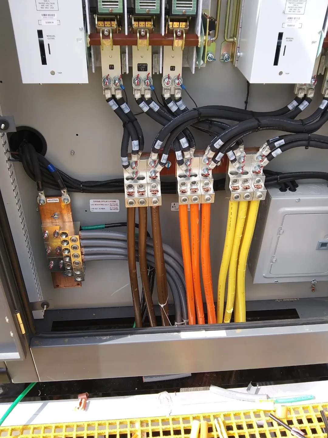 Color-coded commercial feeder conductors terminated inside electrical equipment