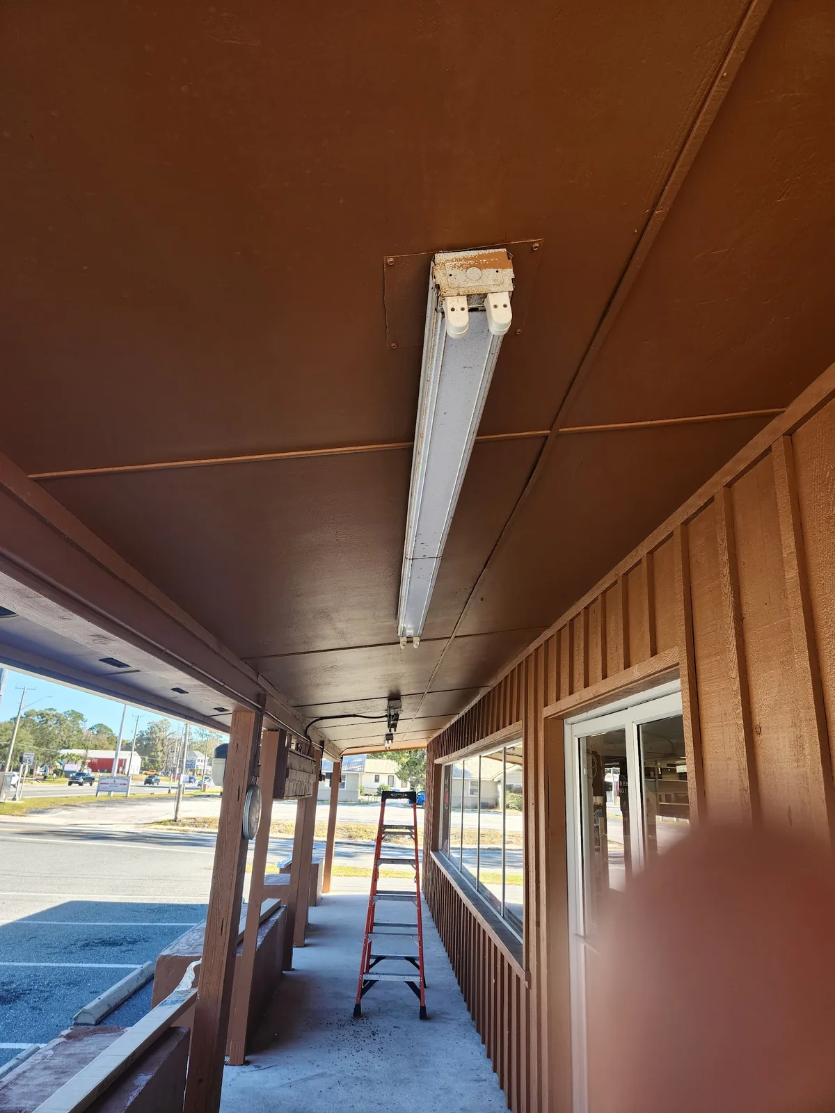 Long covered porch with evenly spaced ceiling lights