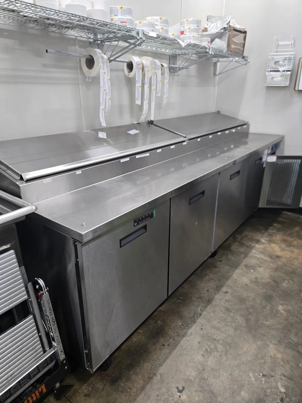 Stainless commercial kitchen work area with new overhead lighting