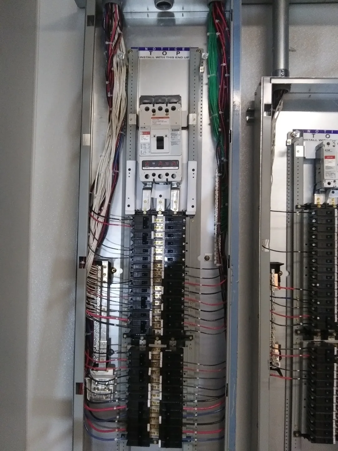Open commercial distribution panel with neatly routed conductors