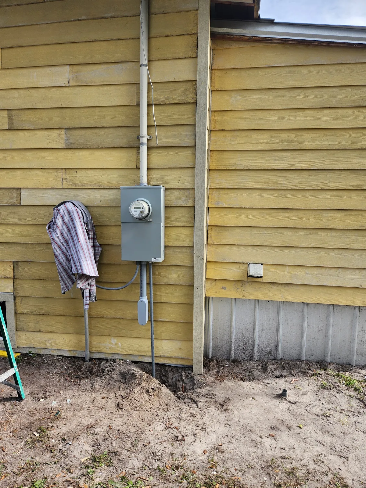Outdoor meter and electrical service equipment mounted on home siding