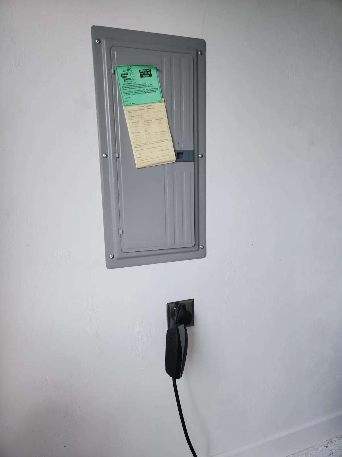 Closed residential breaker panel installed on a finished interior wall