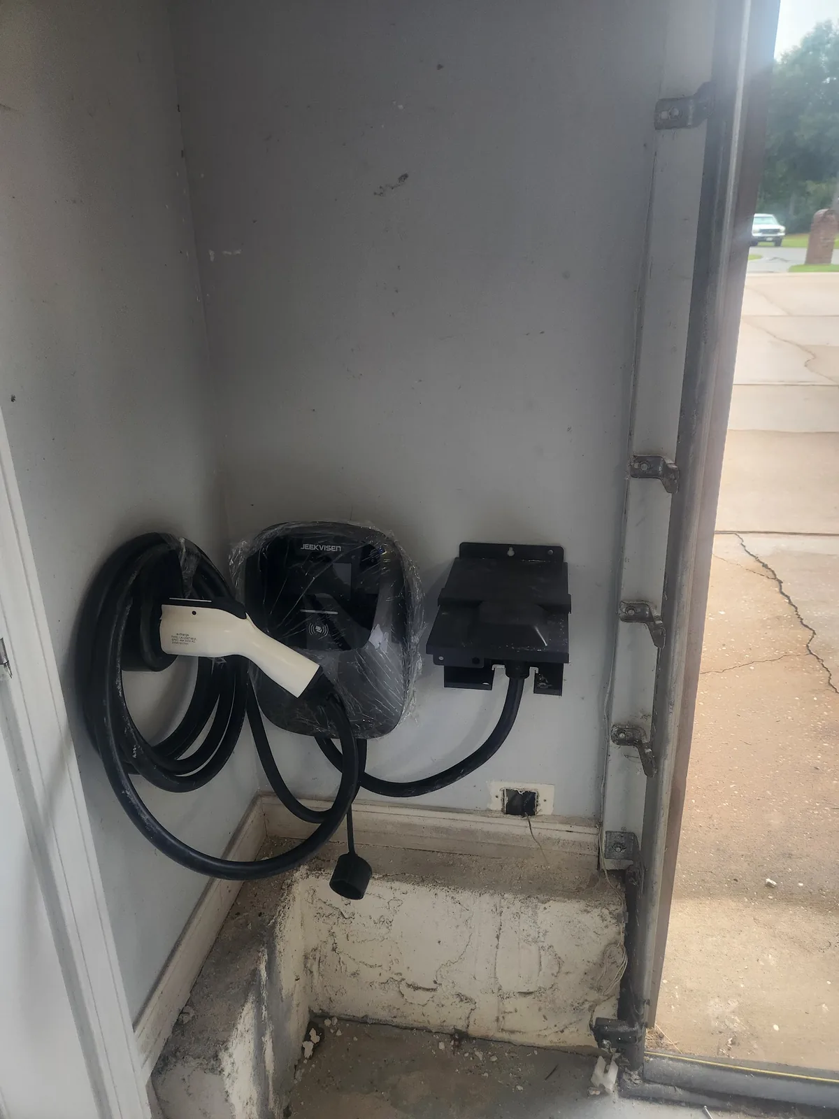 Two electric vehicle charging connectors mounted together