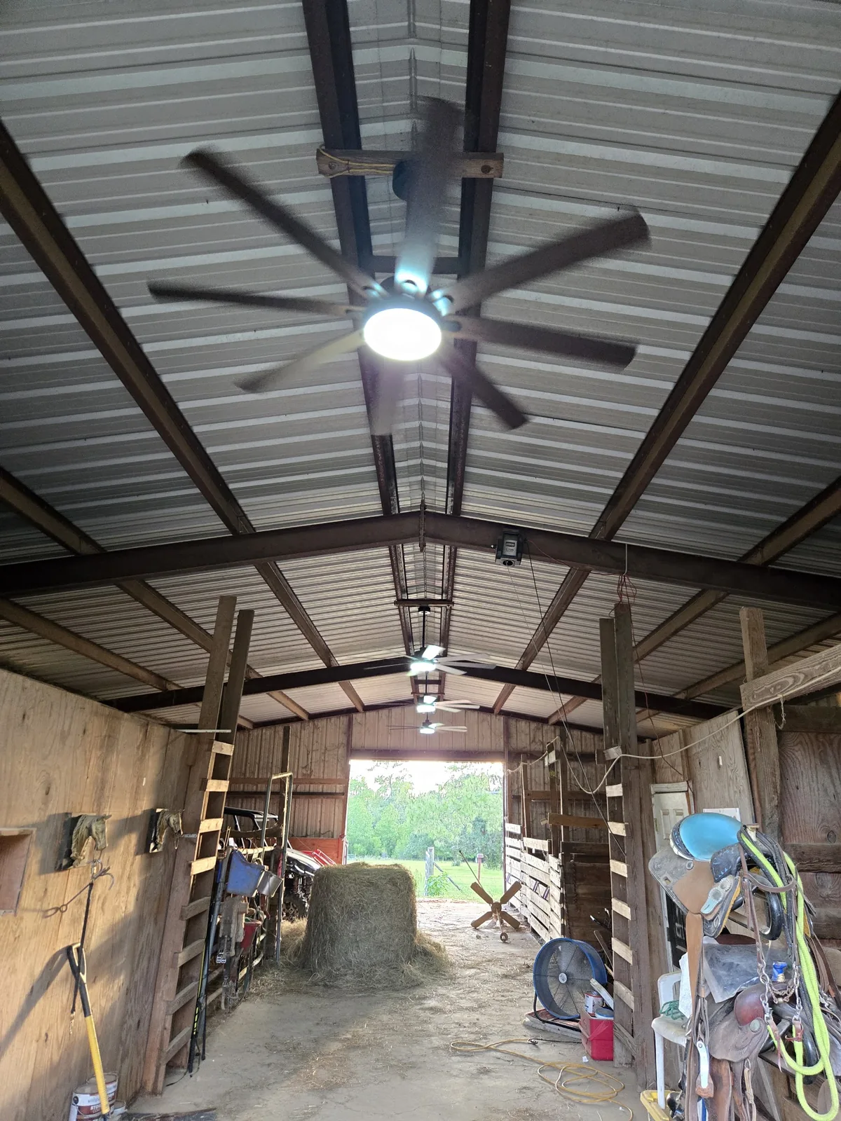 Bright fixtures and ceiling fan installed in a metal shop