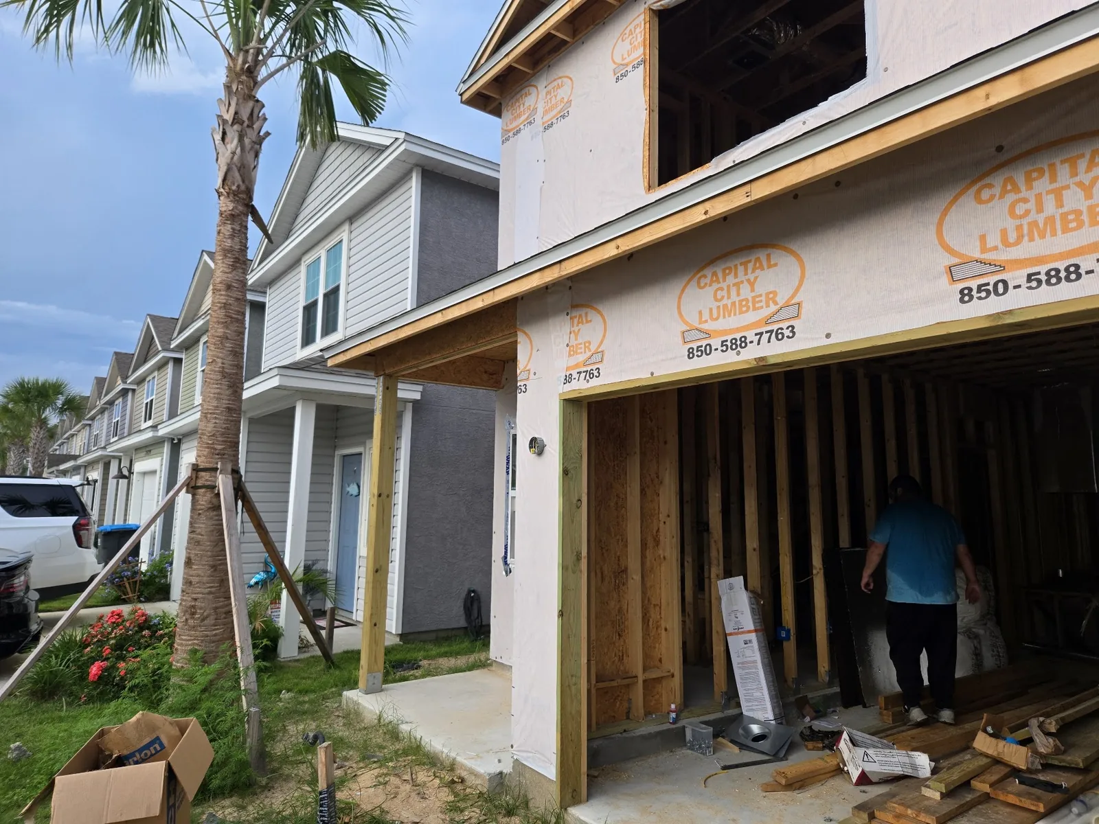 Two-story home under construction with electrical work underway
